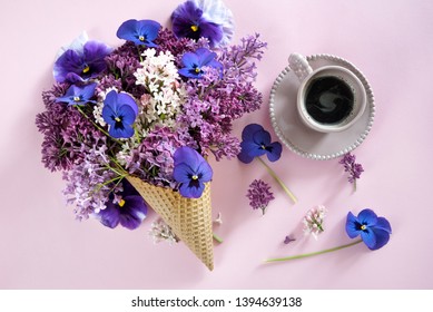 Ice cream of lilac flowers in waffle cone,a cup of coffee on light background from above, beautiful floral arrangement, flat lay styling - Powered by Shutterstock