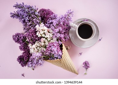 Ice cream of lilac flowers in waffle cone,a cup of coffee on light background from above, beautiful floral arrangement, flat lay styling - Powered by Shutterstock