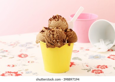 Ice Cream In Metal Cup On Kitchen Table Background