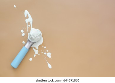 Ice Cream Minimal Background With A Space For A Text, Melting Ice Cream Ball In A Scoop Laid On Splashes, View From Above