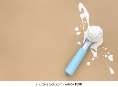 Ice Cream Minimal Background With A Space For A Text, Melting Ice Cream Ball In A Scoop Laid On Splashes, View From Above