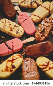 Ice Cream On Stick Coated With Various Chocolate Glazes And Toppings. Top View, Flat Lay