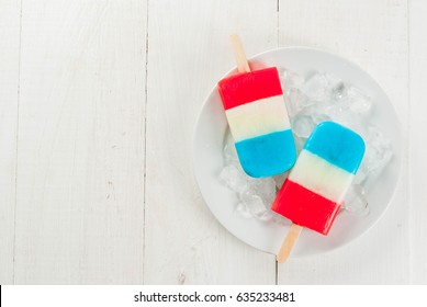 ICe Cream. Patriotic Red White Blue Popsicles For 4th Of July Holiday, On White Wooden Table. Copy Space Top View