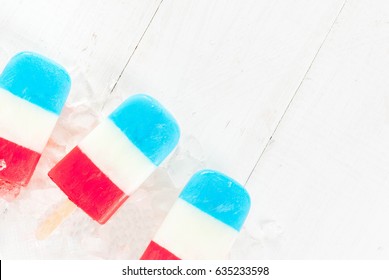 ICe Cream. Patriotic Red White Blue Popsicles For 4th Of July Holiday, On White Wooden Table. Copy Space Top View