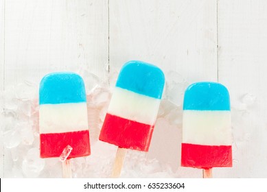 ICe Cream. Patriotic Red White Blue Popsicles For 4th Of July Holiday, On White Wooden Table. Copy Space Top View