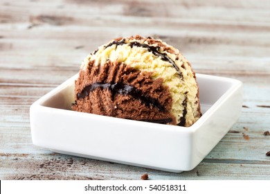Ice Cream Scoop With Chocolate And Caramel In Plate