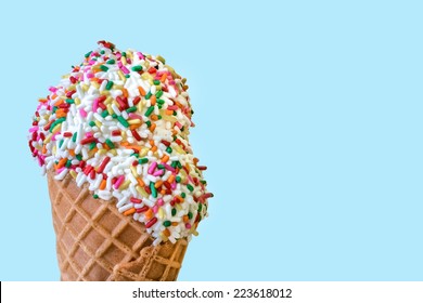 Ice Cream with Sprinkles in a Waffle Cone on a Blue Background