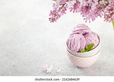 Ice Cream Sundae Bowl And Lilac Flowers. With Copy Space