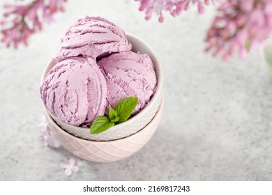 Ice Cream Sundae Bowl And Lilac Flowers. With Copy Space