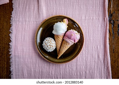 Ice cream Sunday cake pops on plate with donut hole on pink linen - Powered by Shutterstock