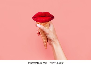 Ice cream waffle cone with red lips inside in a female hand isolated on a color pink background. Trendy creative conceptual collage in magazine style. Contemporary art. Modern design. Summer concept - Shutterstock ID 2124480362