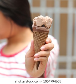 ice cream in young girl hand - Shutterstock ID 1054794635