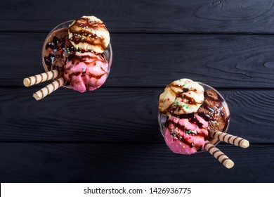 Ice creeam in sundae . Chocolate , vanilla and strawberry