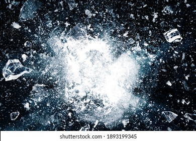 Ice, crushed on black background. Pieces of crushed ice spreading away. The explosion of ice.
