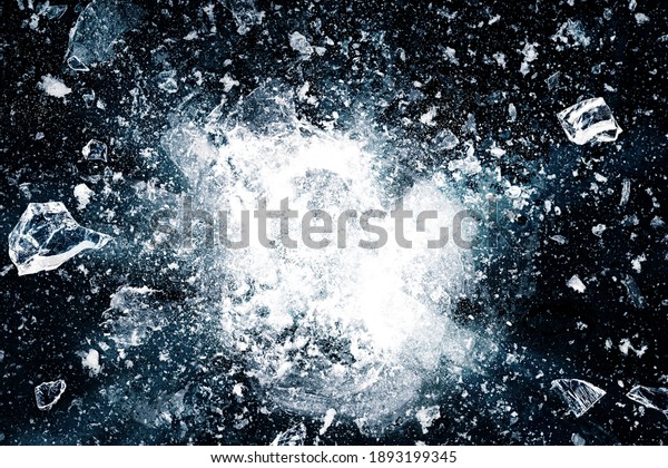 Ice, crushed on black background.\
Pieces of crushed ice spreading away. The explosion of\
ice.