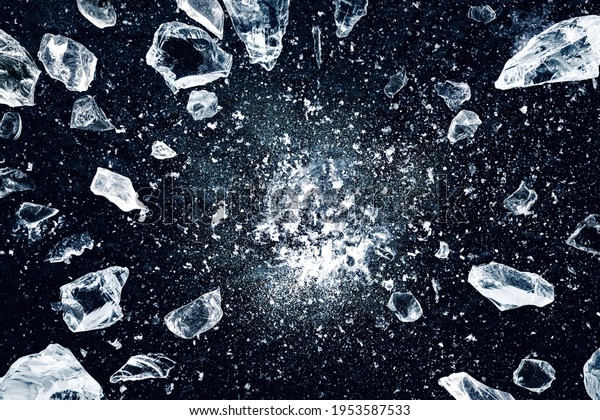 Ice, crushed on black background.\
Shards of crushed ice spreading away. The explosion of\
ice.