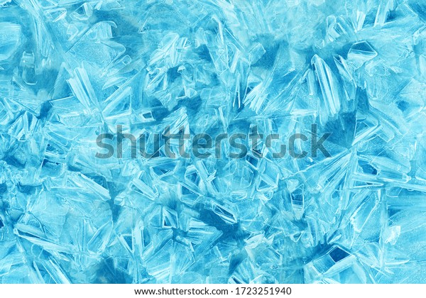 Ice crystal texture. Transparent ice\
crystals cracked background. Frozen water\
surface