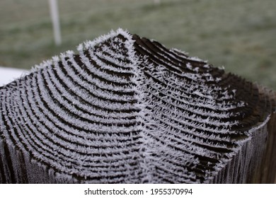 Ice Crystals Growing In Patterns On A Fence Post In Winter.