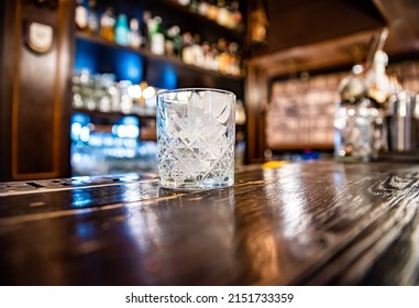 Ice Cube In An Empty Glass On A Bar Counter In Bar Or Pub