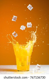 Ice Cube Splash In A Glass With Orange Soda