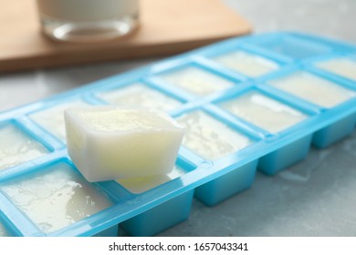 Ice Cube Tray With Frozen Milk On Grey Table, Closeup