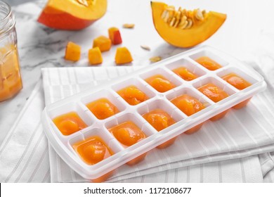 Ice Cube Tray With Healthy Baby Food On Table