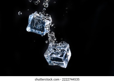 ice cube in water jet on black background - Shutterstock ID 2222744535