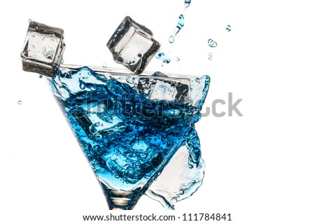 Ice cubes in broken glass with blue martini on white background