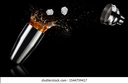 Ice Cubes And Cocktail Spilling Out Of A Shaker Isolated On Black Background