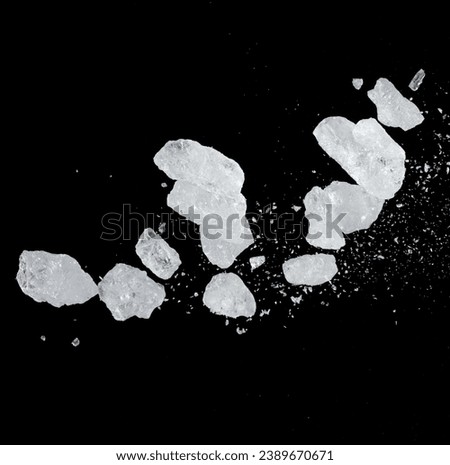 Ice Cubes explosion flying, crystal clear ice wave floating, fall down in air. Ice Brick crack cube is frozen water healthy thirsty. Black background Isolated high speed shutter, freeze stop motion