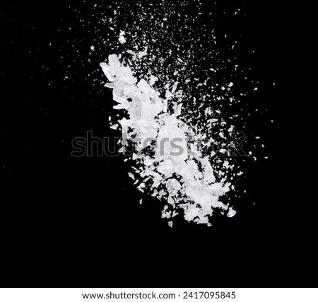 Ice Cubes explosion flying, crystal clear ice wave floating, fall down in air. Ice Brick crack cube is frozen water healthy thirsty. Black background Isolated high speed shutter, freeze stop motion