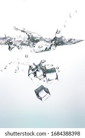 Ice cubes falling into the clear water Create beautiful bubbles