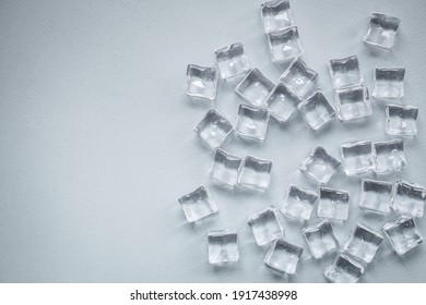 ice cubes imitation artificial plastic pieces transparent acrylic not real cold, illusion ready to eat on the table outdoor top view copy space for text food background