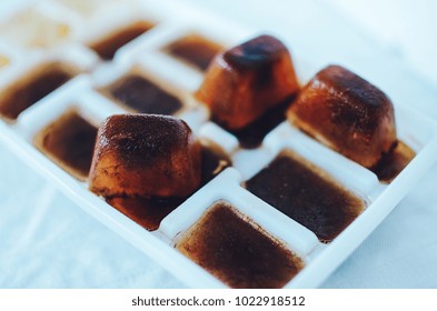 Ice Cubes Made With Coffee In Ice Cube Tray To Prepare Refreshing Coffee Drinks, Close Up On White Background