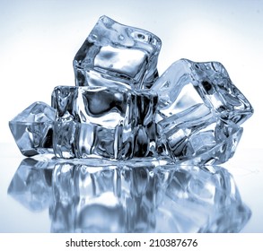 Ice cubes on blue background - Shutterstock ID 210387676