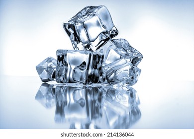 Ice cubes on blue background - Shutterstock ID 214136044