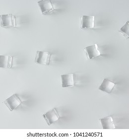 Ice cubes pattern on bright background. Flat lay summer drink minimal concept.