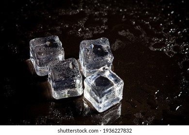 Ice Cubes Reflection On Black Table Background.