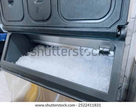 Ice cubes store in ice making machine for clean product. Ice cube maker. Cube ice machine. Suitable for small beverage shops.