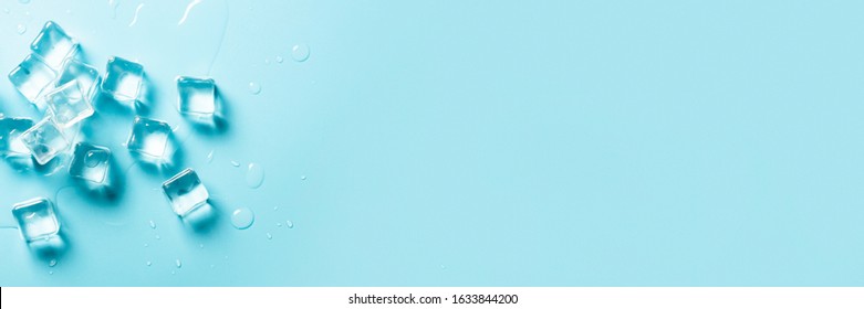 Ice Cubes With Water On A Blue Background. Ice Concept For Drinks. Banner. Flat Lay, Top View