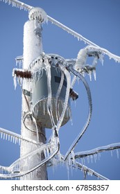 Ice Encrusted Power Lines And Transformer On A Brilliant Winter Day.