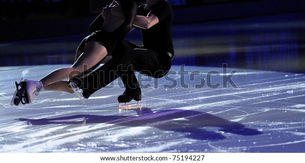 Ice figure\
skating pair with shadows on\
ice