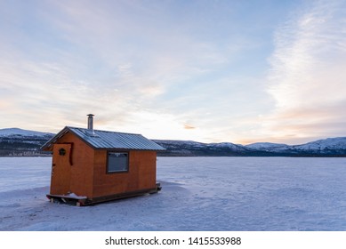 Ice Fishing Cabin On A Frozen Lake In The Yukon Territory, Canada