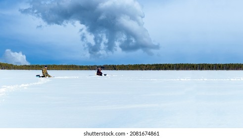 Ice fishing. fishermans fishing on frozen lake. Winter frosty morning fishing on river. Copy space - Powered by Shutterstock