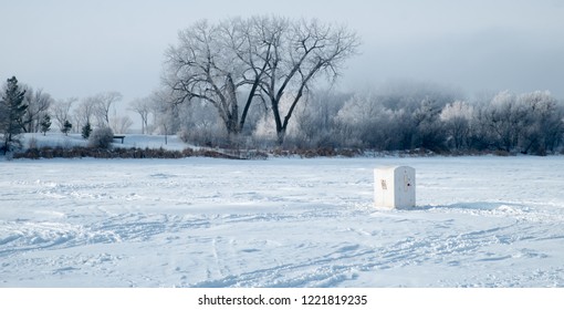 Ice Fishing House On Frozen Lake In Winter