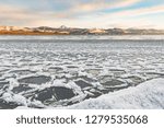 Ice floes gathering at shore of Lake Laberge, Yukon Territory, Canada, before winter freeze up