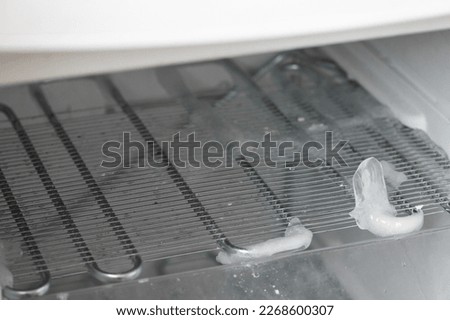 Ice full in empty freezer of a refrigerator makes refrigerator work harder and broken. Broken refridgerator. Freezer problem.