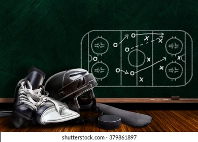 Ice hockey equipment consisting of skates, helmet, stick and puck with background play strategy drawn on chalk board with copy space. - Powered by Shutterstock