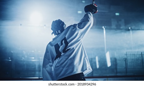 Ice Hockey Game: Professional Player Celebrating Victory On Rink, Raising Arms. Joyful Young Athlete Became A Champion, Through Effort And Determination.