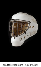 Ice hockey goalie mask. White helmet with dark wires. Isolated on black.
